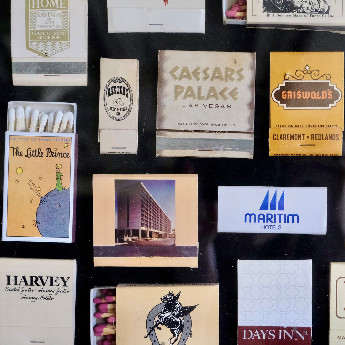 A collage of vintage matchbooks and matchboxes displayed against a dark background, featuring hotel and brand names such as Maritim Hotels, Days Inn, Royal Inn, Harvey, and Caesars Palace.