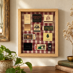 A framed vintage matchbox collage displayed on a wall in a styled room setting. The light wood frame contains various vintage matchboxes, matchbooks, and small photos arranged over a red-and-white gingham fabric background.
